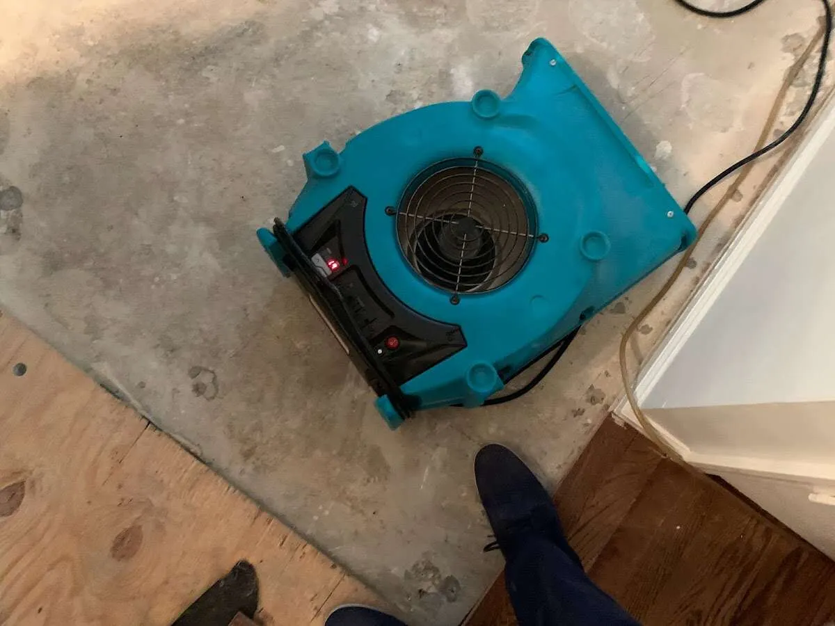 Air mover drying subfloor during Commercial Water Damage Restoration in Cleveland